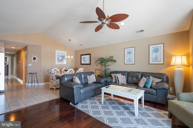 living room with lofted ceiling, wood-type flooring, and ceiling fan with notable chandelier