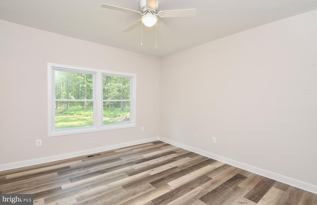 empty room featuring ceiling fan and light hardwood / wood-style flooring