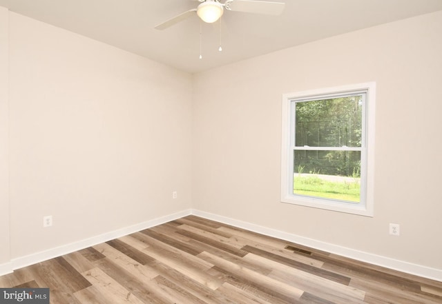 spare room featuring ceiling fan and light hardwood / wood-style floors