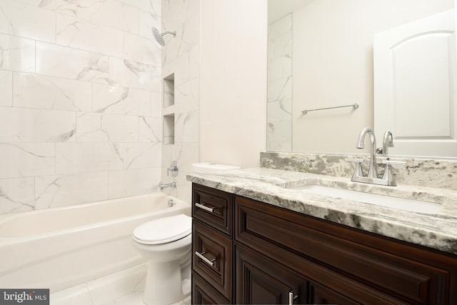 full bathroom with tiled shower / bath, vanity, and toilet