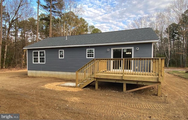 rear view of property featuring a deck