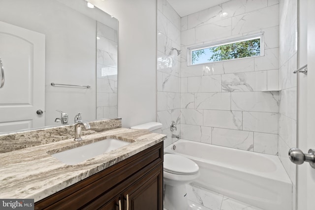 full bathroom featuring tiled shower / bath combo, vanity, and toilet