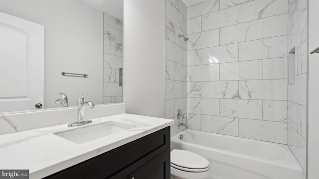 full bathroom with vanity, toilet, and tiled shower / bath