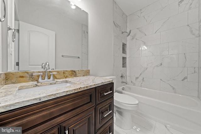 full bathroom with tiled shower / bath, vanity, and toilet