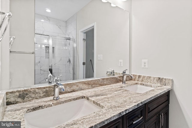 bathroom featuring vanity and a shower with shower door