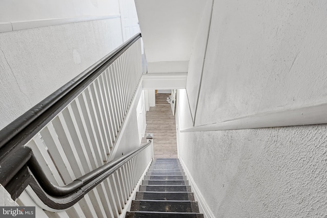 staircase featuring wood finished floors