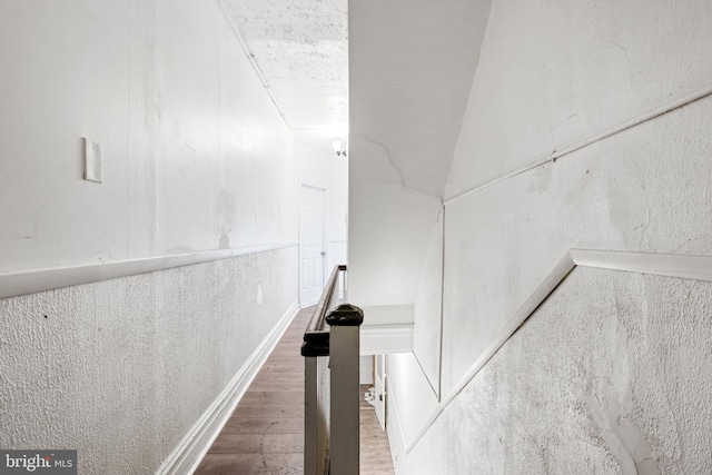 staircase with wood finished floors