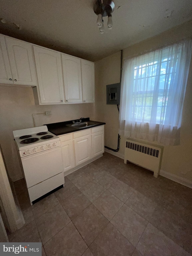 kitchen featuring radiator heating unit, white electric range, electric panel, white cabinets, and sink