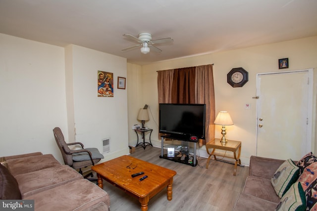 living room with ceiling fan and light hardwood / wood-style flooring