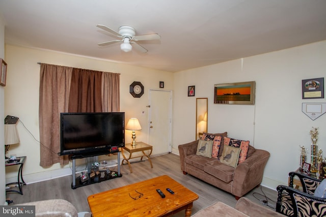 living room with ceiling fan and hardwood / wood-style flooring