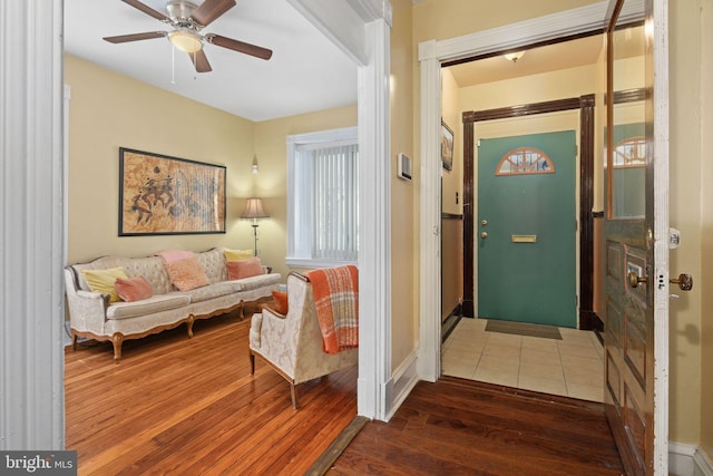 foyer entrance featuring ceiling fan and dark wood-type flooring