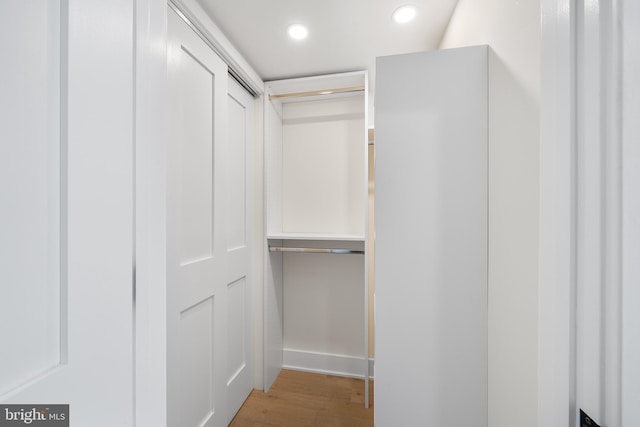 spacious closet with hardwood / wood-style flooring