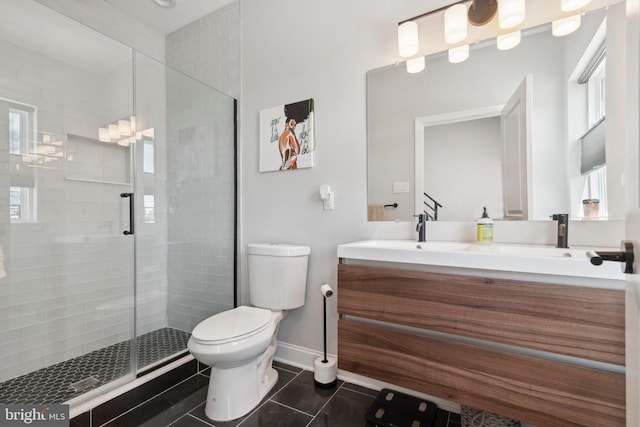 bathroom with toilet, vanity, tile patterned flooring, and an enclosed shower