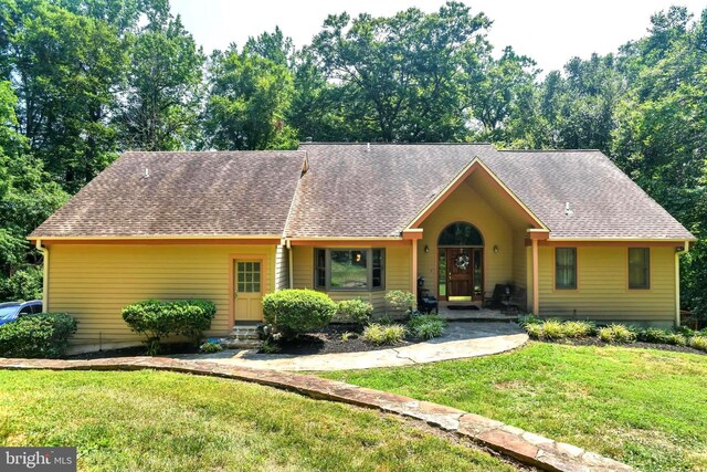 rear view of house featuring a yard and a wooden deck