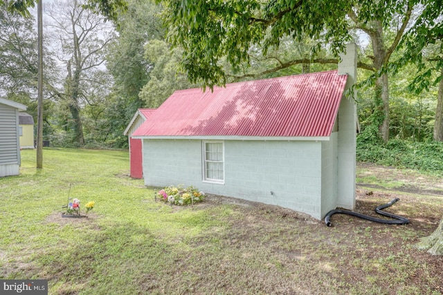 view of side of home featuring a lawn