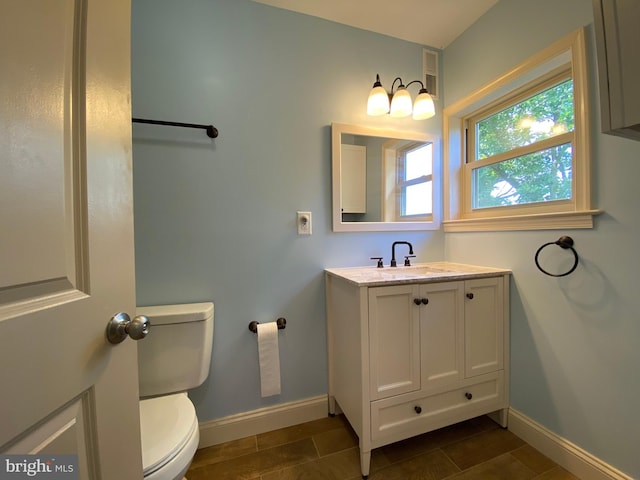 bathroom featuring toilet and vanity