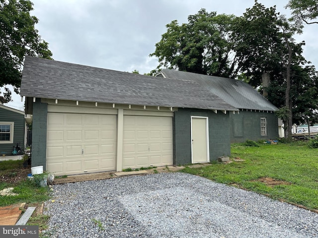 garage featuring a lawn