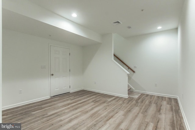 basement with light hardwood / wood-style flooring