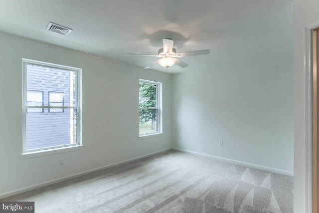 unfurnished room featuring ceiling fan and light carpet