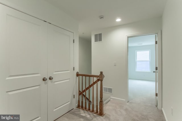 hallway with light carpet