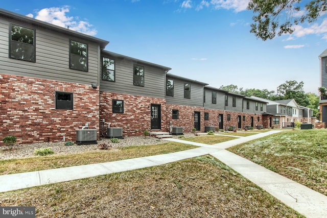 exterior space featuring a front yard and central air condition unit