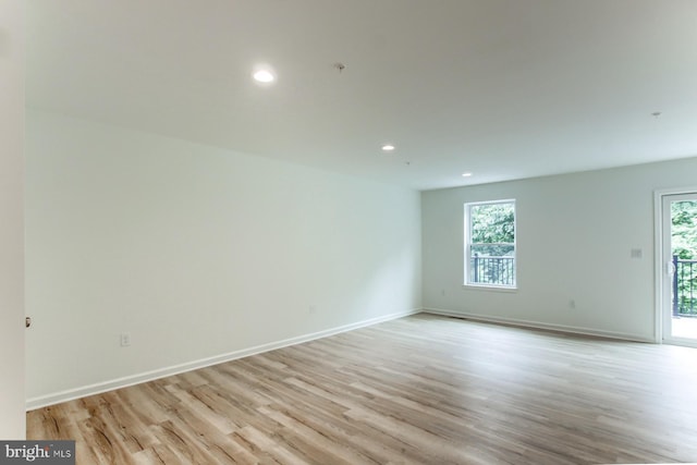 spare room with a healthy amount of sunlight and light wood-type flooring