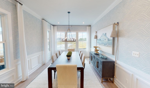 dining area with ornamental molding and light wood-type flooring