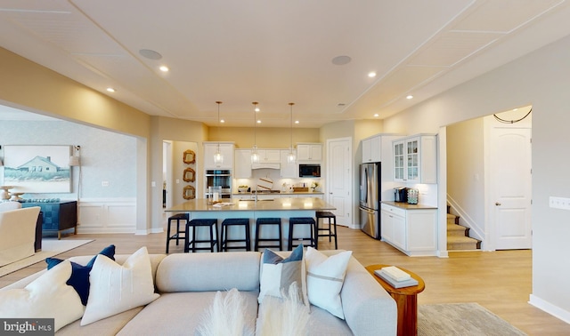 living room featuring light hardwood / wood-style flooring and sink