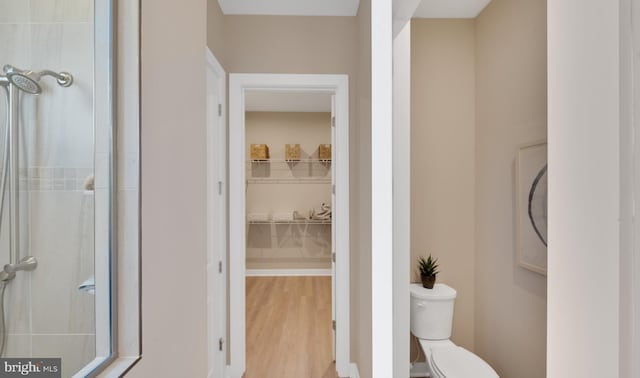 bathroom with toilet and wood-type flooring