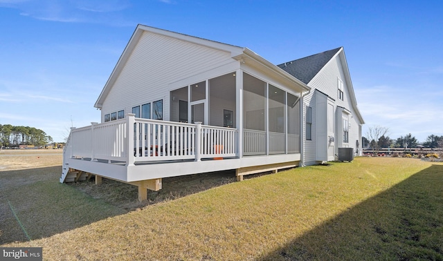 view of property exterior with a yard, a sunroom, and central AC