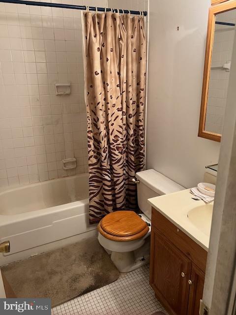 full bathroom featuring tile patterned floors, shower / bath combo, toilet, and vanity