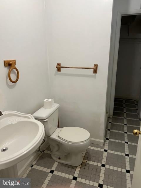 bathroom with tile patterned flooring, toilet, and sink