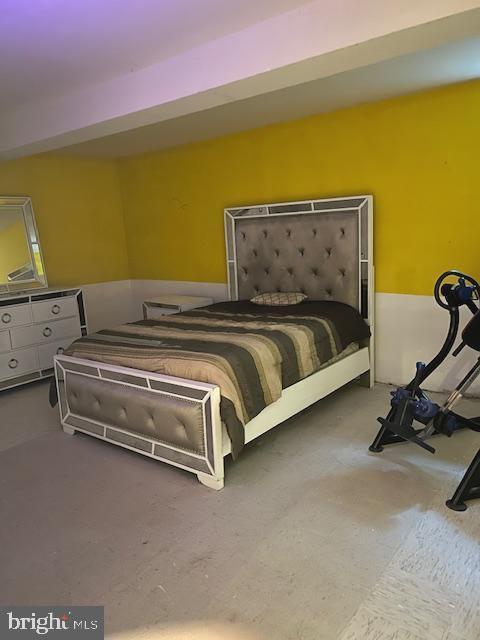 bedroom featuring concrete flooring