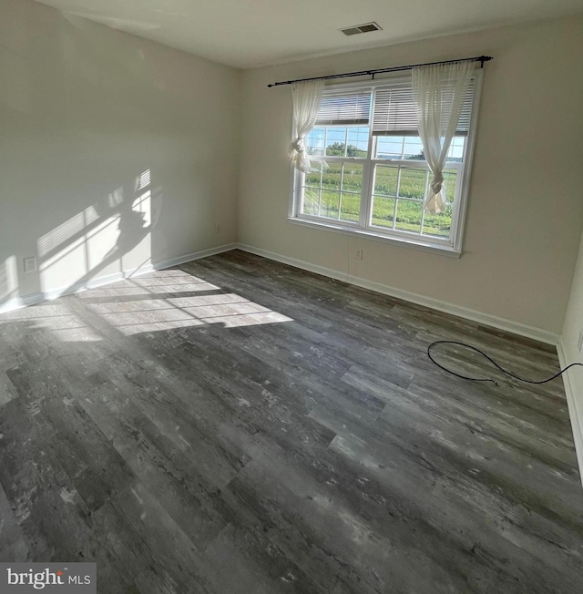 unfurnished room featuring hardwood / wood-style flooring