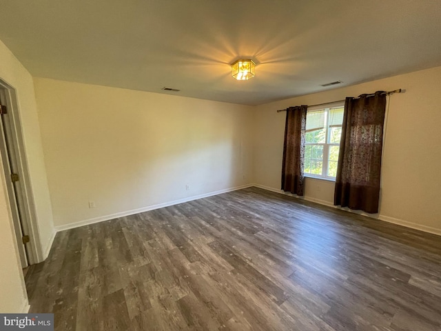 spare room featuring dark hardwood / wood-style floors