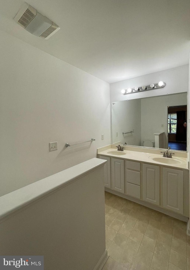 bathroom with tile patterned floors and vanity