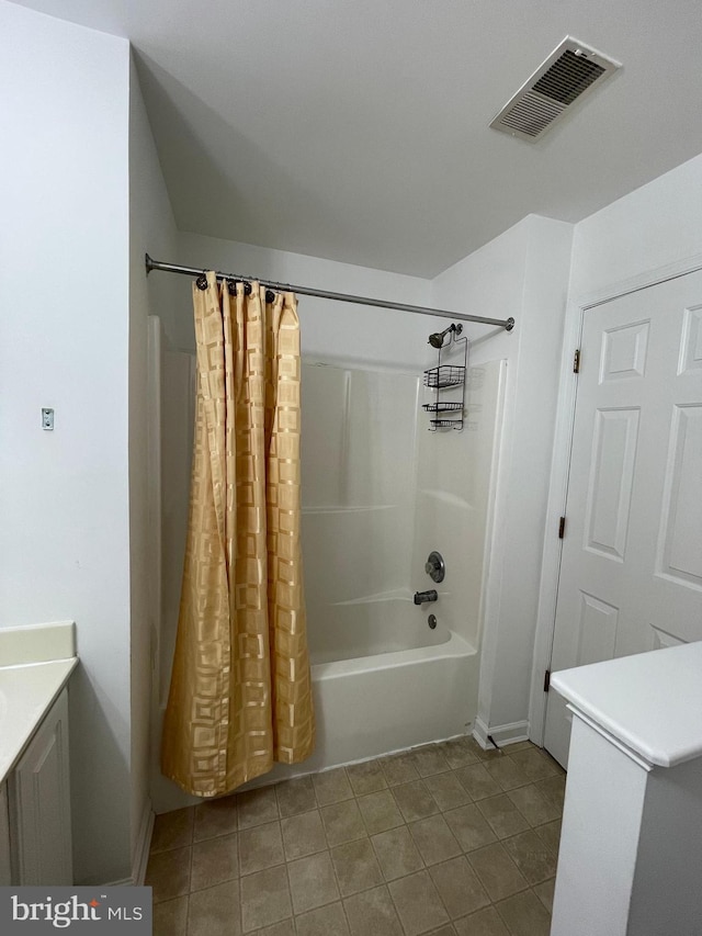 bathroom featuring tile patterned flooring, vanity, and shower / tub combo