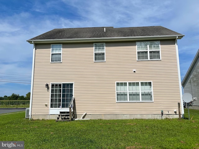 back of property featuring a lawn