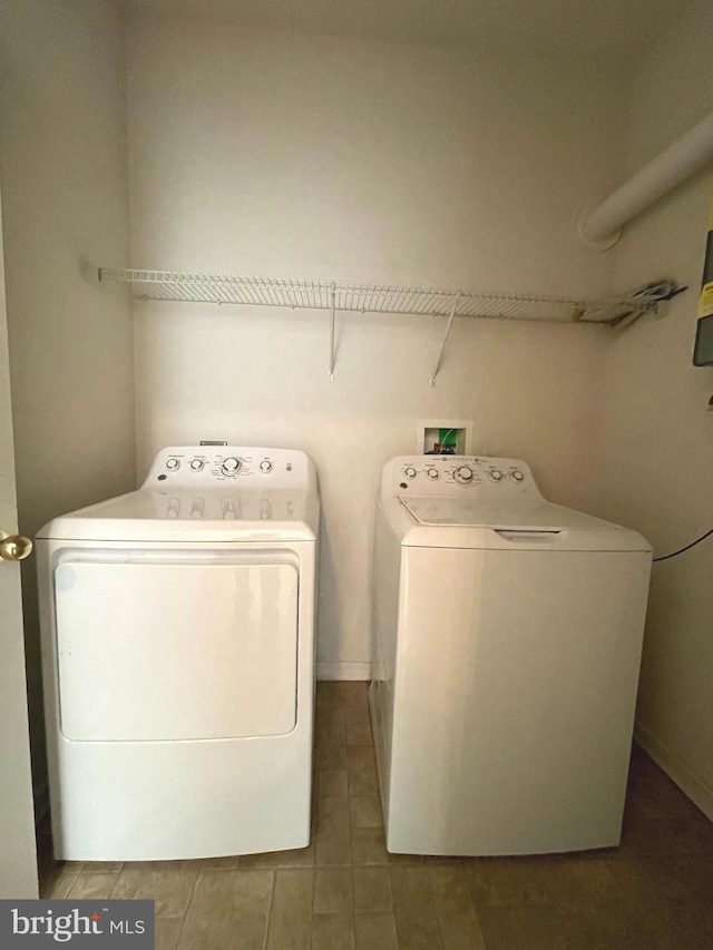 clothes washing area featuring washer and dryer and tile patterned flooring