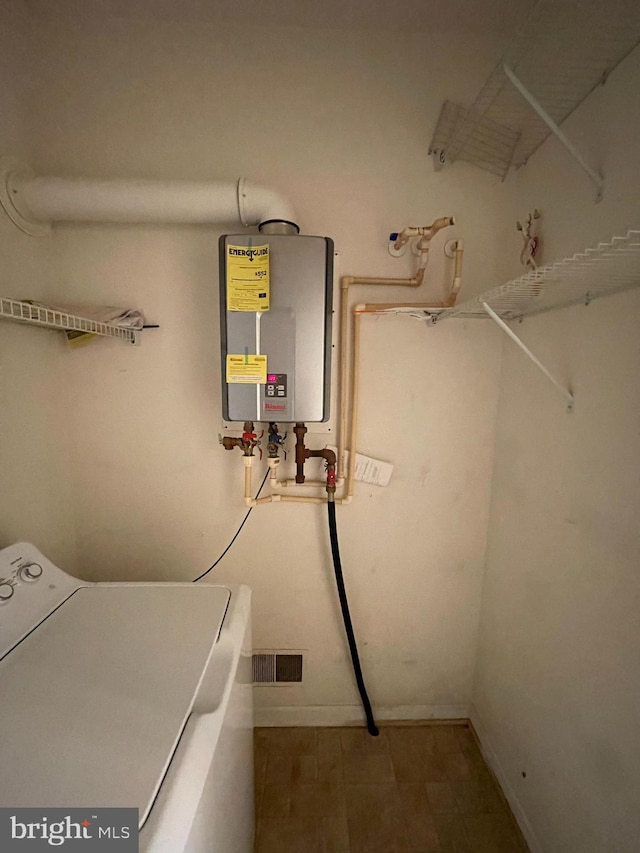 utilities featuring tankless water heater and washer / dryer