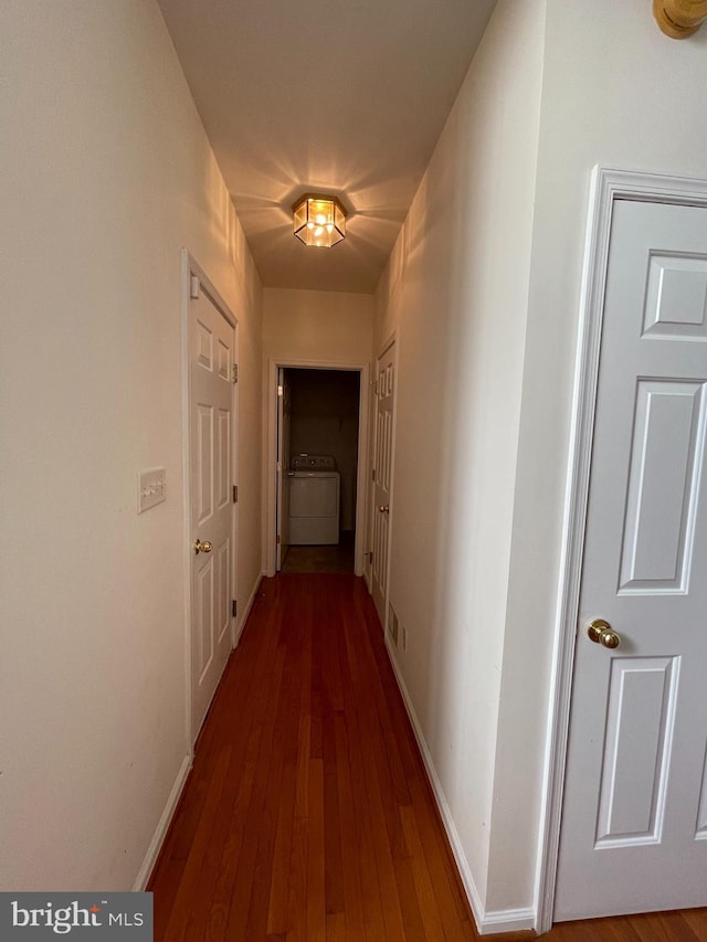 hall featuring hardwood / wood-style floors and washer / dryer