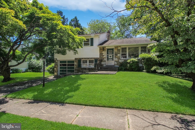 split level home featuring a front lawn