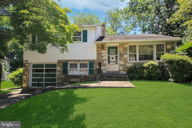 tri-level home featuring a garage and a front lawn