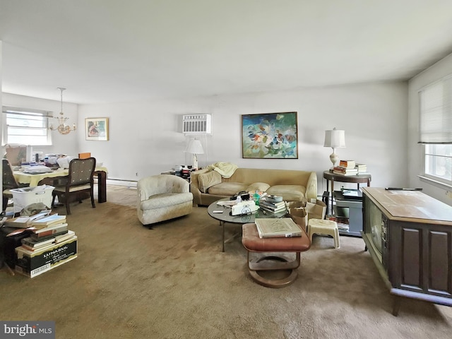 living room featuring an inviting chandelier, plenty of natural light, and dark colored carpet