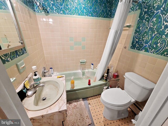 full bathroom with vanity, tile patterned floors, tile walls, shower / bath combination with curtain, and toilet