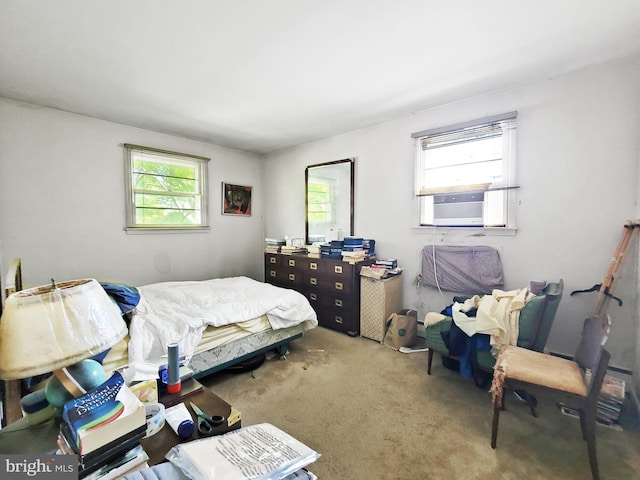 carpeted bedroom featuring multiple windows and cooling unit