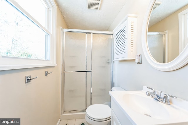 bathroom with walk in shower, tile patterned floors, toilet, and a textured ceiling