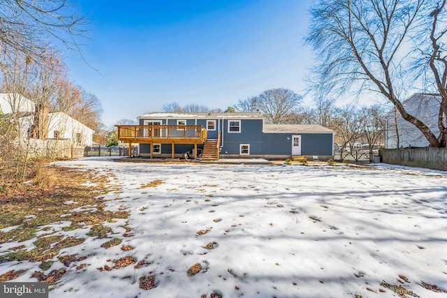 snow covered property with a wooden deck