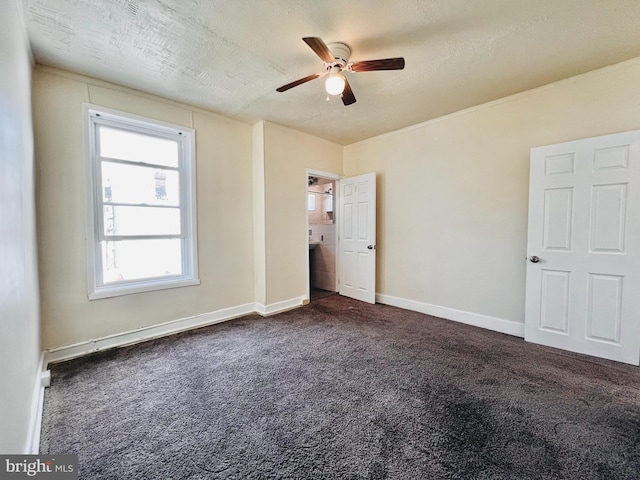 unfurnished bedroom with ceiling fan, dark carpet, and a textured ceiling