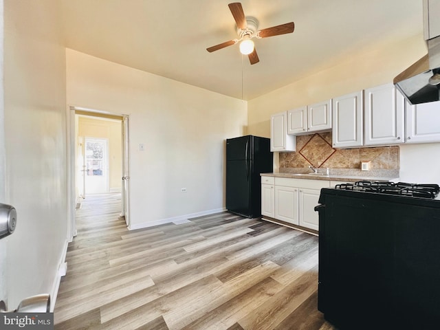 kitchen with black appliances, decorative backsplash, extractor fan, and white cabinetry